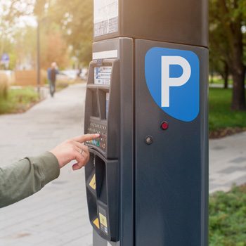 parking-machine-in-the-city-street-terminal-for-paying-car-parking-man-s-hand-presses-button